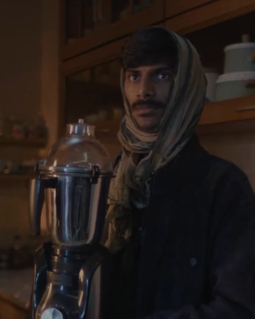 J D Ayush Kumar in the Swiggy Instamart commercial - looking to camera behind a mixer-grinder
